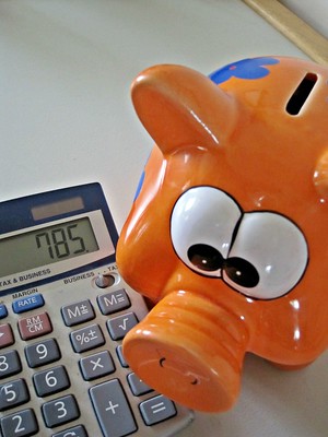 piggy bank and calculator credit card debt