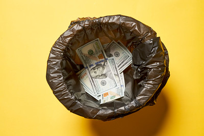 wastebasket of money executive compensation