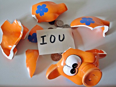 broken piggy bank with IOU. instructor salary